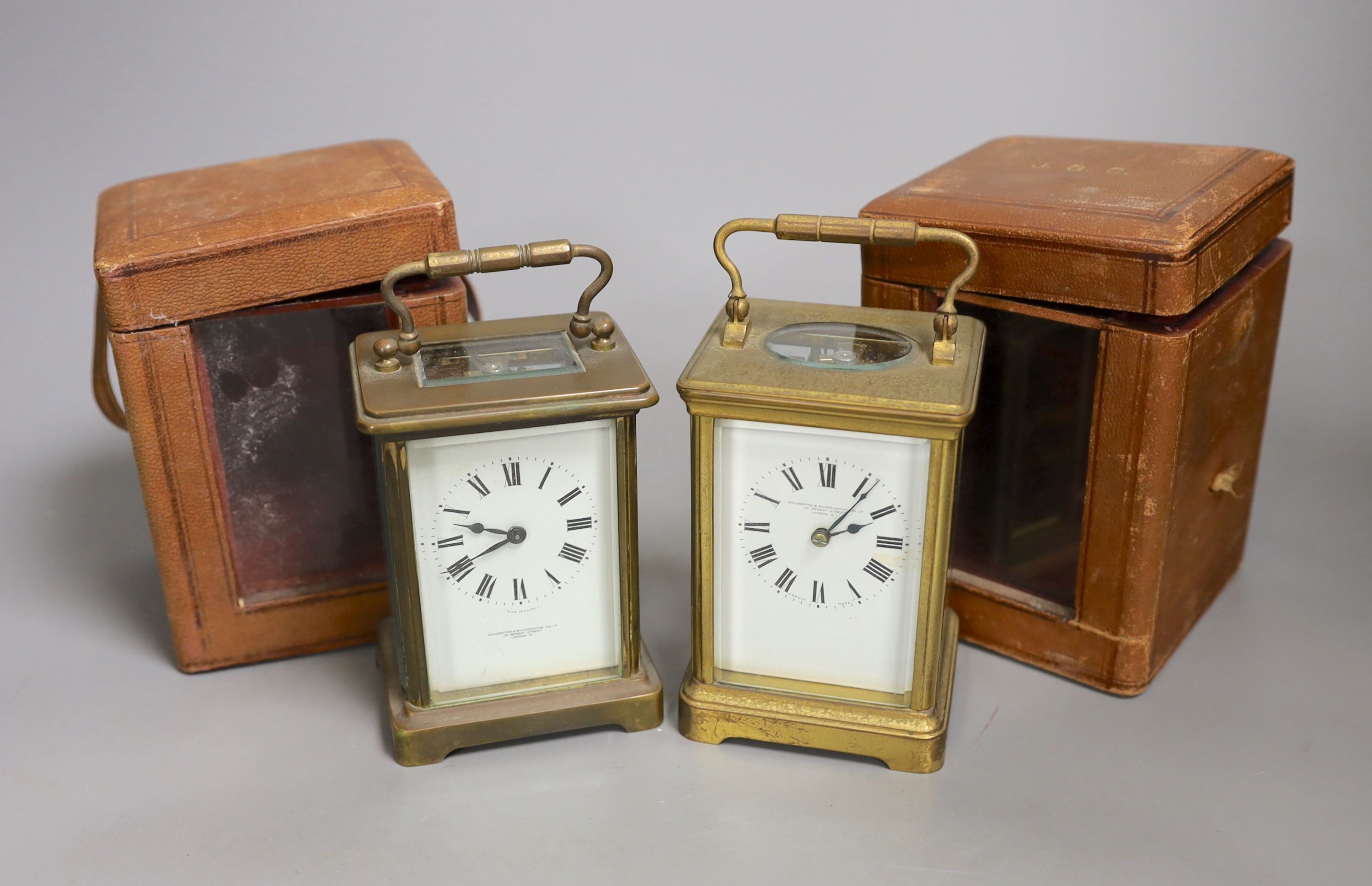 Two leather cased brass carriage timepieces, 14 cms high including case.